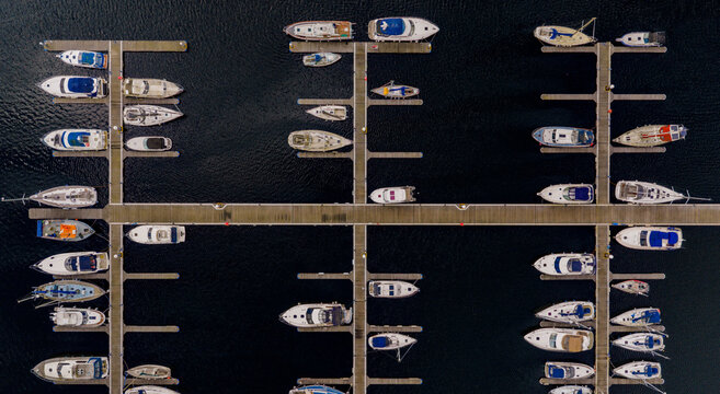 Aerial view of MDL Chatham Maritime Marina with numerous yachts and boats moored at the pontoons in Chatham, England, United Kingdom.
