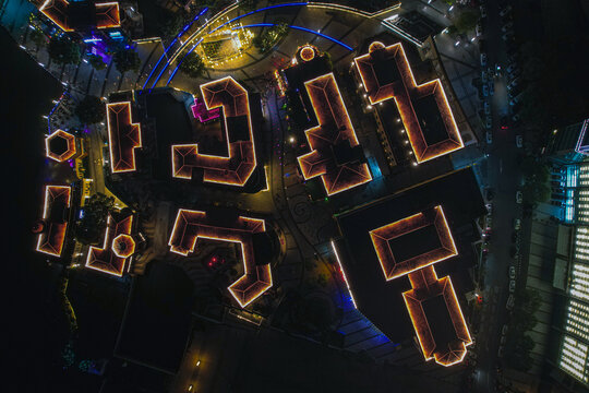 Aerial view of Harmony Times Square in Suzhou at night, featuring illuminated rooftops and modern urban architecture in Suzhou, Jiangsu, China.