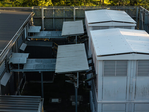 Aerial view of a traction substation featuring white modular units, metal roofing, and complex electrical cabling in Rouse Hill, Sydney, New South Wales, Australia.