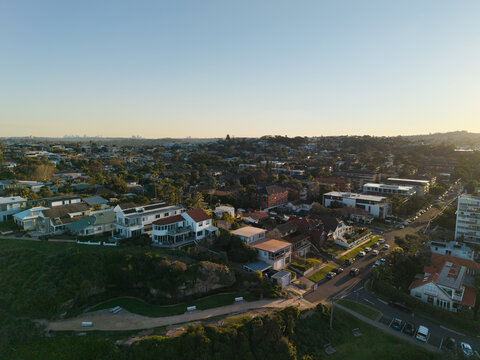 Aerial view of residential houses and streets in the coastal suburb of Dee Why during golden hour in Dee Why, New South Wales, Australia.