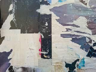 Grungy, torn, and ripped street poster background, messy old paper artistic texture © DaliCeMedia