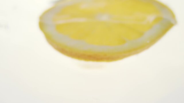 Macro close up of a slice of Orange  splashing in water in slow motion