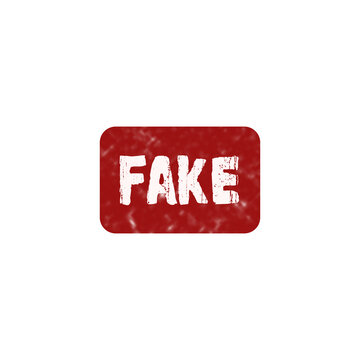 Red rubber stamp with the word fake written in white bold capital letters for document marking and verification