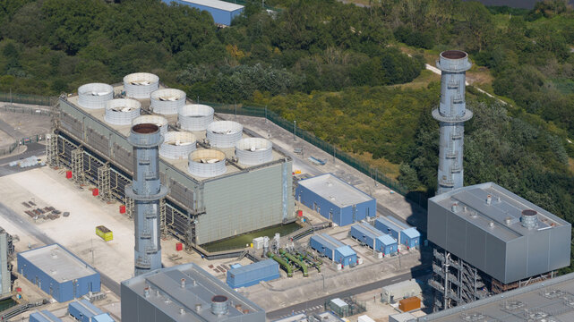 Aerial view of West Burton Power Station featuring industrial cooling towers, tall chimneys, and surrounding infrastructure in West Burton, England, United Kingdom.