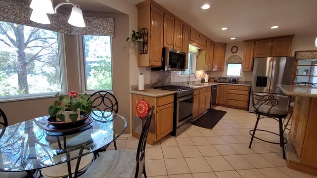 Narrow kitchen passage with stainless refrigerator dining area bright open layout