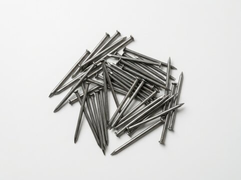 A pile of sharp iron metal nails scattered on a white background