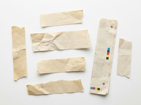 A collection of various aged paper strips with rough torn ragged edges