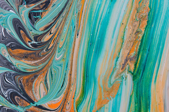 Striking fluid artwork with swirling turquoise, teal, orange, and dark grey paint in motion.
