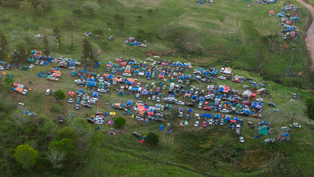 Aerial view of Rally Paraguay 2026 campsite featuring numerous colorful tents and parked vehicles scattered across a grassy hillside in Nueva Alborada, Itapua Department, Paraguay.