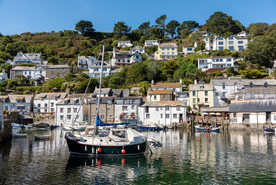 Polperro Cornwall England UK. 13.08.2026. Polperro a charming coastal village with traditional houses nestled on a hillside overlooking a tranquil harbour filled with various boats