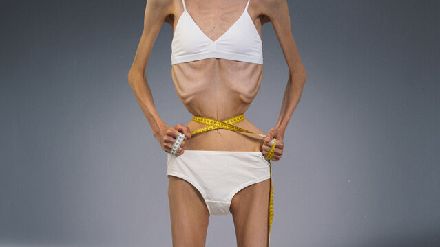  Skinny young woman with anorexia on free brown background