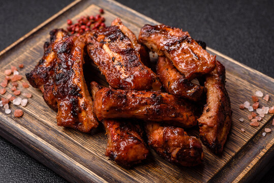 Grilled pork or beef ribs seasoned with salt and spices, served in sauce. Grilled ribs