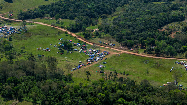 Aerial view of Rally Paraguay 2026 with spectators parked along a dirt road in a rural landscape in Nueva Alborada, Itapua Department, Paraguay.