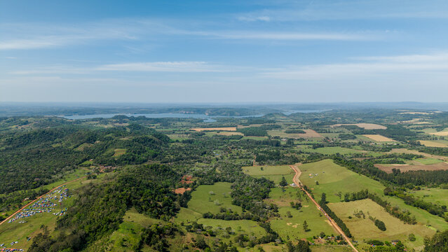 Aerial view of the Rally Paraguay 2026 event area featuring rolling green hills, dirt tracks, and spectator camping zones in Nueva Alborada, Itapua Department, Paraguay.