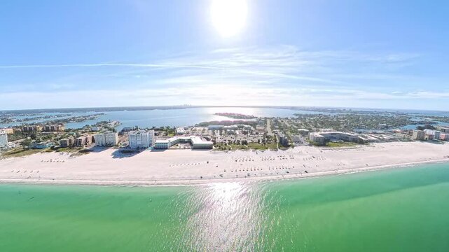 Travel and Tourism: 4K Aerial Drone View of the White Sand Beach, Waves, and Oceanfront Resorts at St. Pete Beach, Florida
