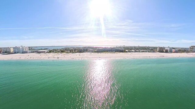 Travel and Tourism: 4K Aerial Drone View of the White Sand Beach, Waves, and Oceanfront Resorts at St. Pete Beach, Florida