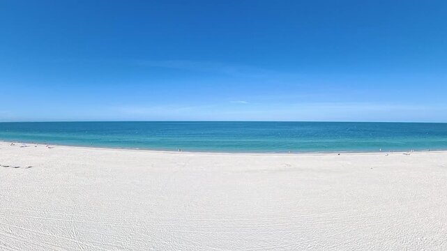 Travel and Tourism: 4K Aerial Drone View of the White Sand Beach, Waves, and Oceanfront Resorts at St. Pete Beach, Florida