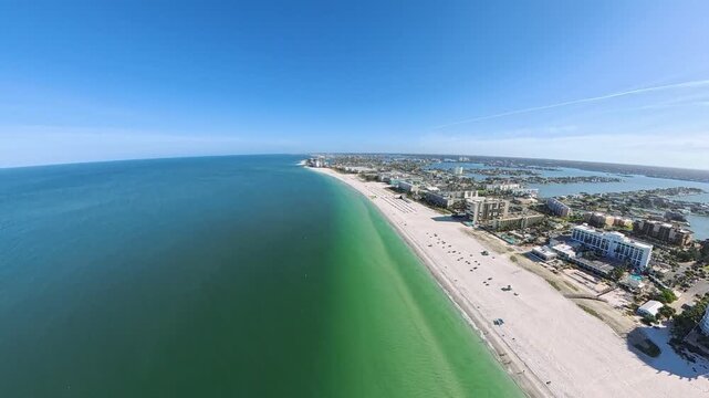 Travel and Tourism: 4K Aerial Drone View of the White Sand Beach, Waves, and Oceanfront Resorts at St. Pete Beach, Florida