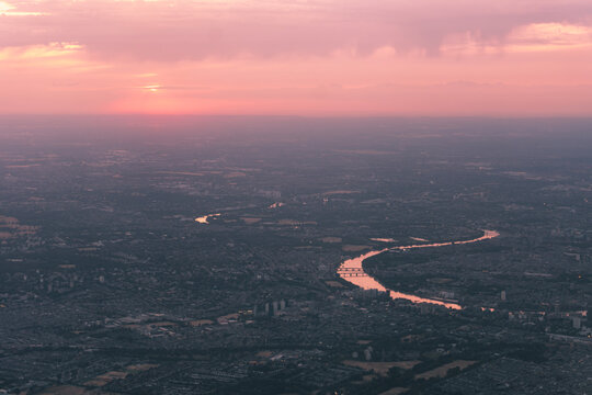 Travel and Geography: Aerial View of River Thames Winding Through Greater London and Countryside at Sunset with Golden Glowing Water