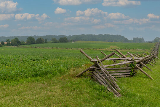 History and Landscape: Wooden Worm Fence Bordering Green Agricultural Fields at Gettysburg National Military Park, Pennsylvania