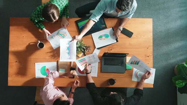 Top down view of smart business people hand working together to analyze chart. Skilled marketing team discussing about financial plan at table with stock market exchange report placed. Convocation.