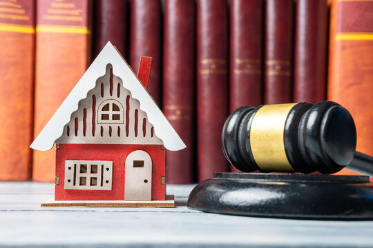 Judge's gavel with a model of a house