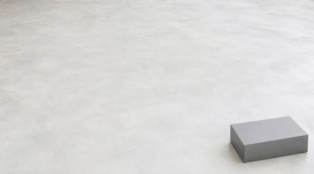 Minimalist grey gift box on concrete floor layout