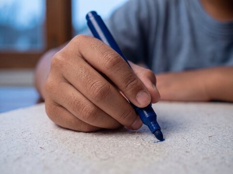Southeast Asian Boy Brainstorming Ideas on Flip Chart