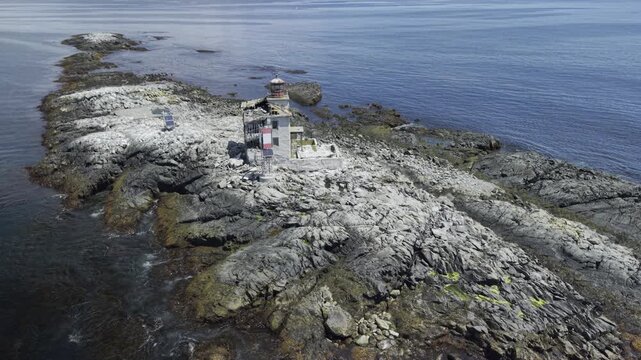 Derelict Gull Rock Lighthouse bestrides a guano encrusted Atlantic rock outcropping 5km south of picturesque fishing village Lockeport, Nova Scotia Canada. MAX QUAL PRORES422HQ 4K HLG HDR BT.2100.