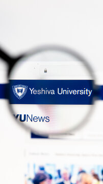Milan, Italy 2026, 15 AGO Closeup of Yeshiva University website page on a laptop screen. Focus on Yeshiva University logo under a magnifying glass.