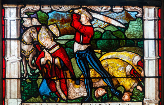 A medieval stained glass panel depicts the Martyrdom of Saint Denis of Paris.