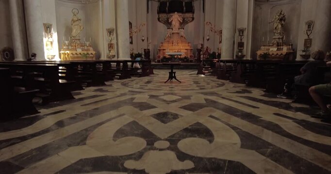 Low Angle Tilt Up Reveal of Ornate Marble Floor and Chandelier Inside Badia di Sant Agata Church in Catania, Italy