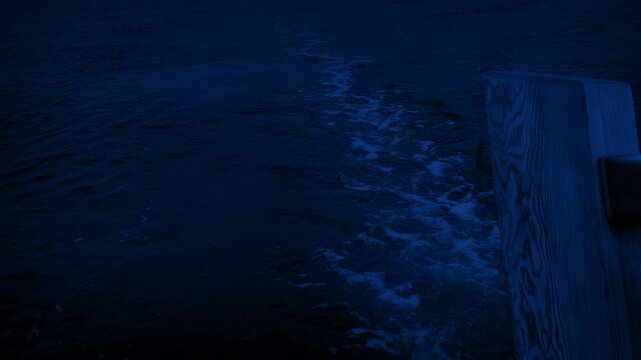 View Behind Boat With Rudder Sailing At Night
