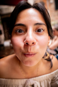 Close-up portrait of a woman making a playful expression