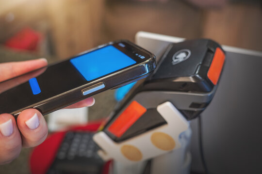 Contactless mobile payment smartphone POS terminal NFC digital wallet transaction, cashless fintech technology, secure retail checkout and banking innovation.
