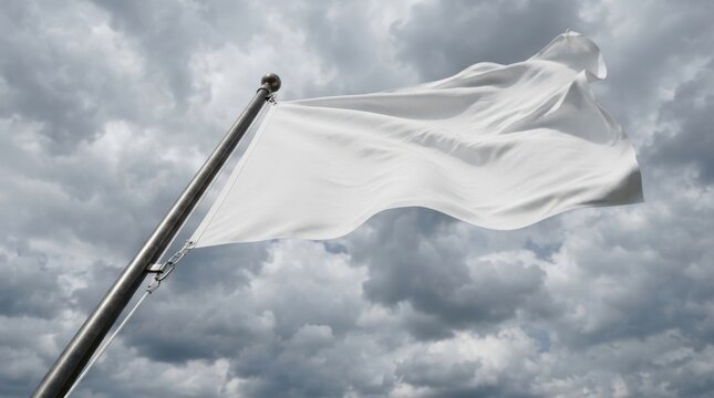 White flag waving on flagpole against stormy cloudy sky