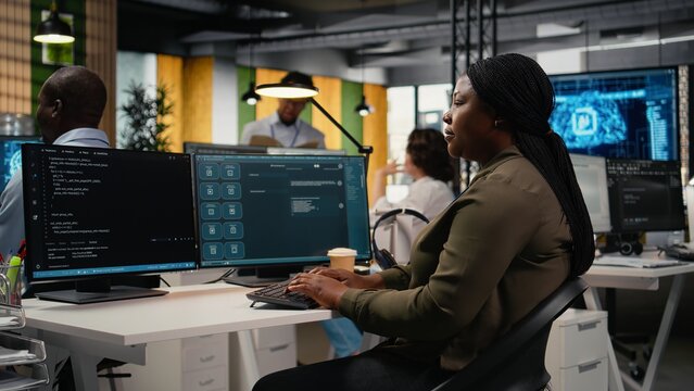 Engineer in an office uses an AI LLM chatbot to optimize performance, while the IT employee works with a generative artificial intelligence assistant for faster software development.