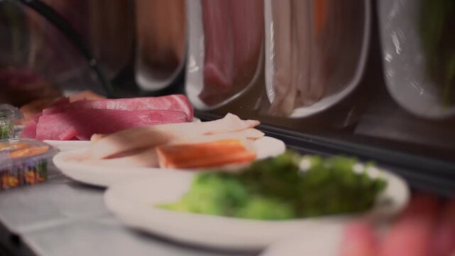 Fresh Seafood and Wakame Seaweed Ingredients Displayed in Sushi Bar Showcase