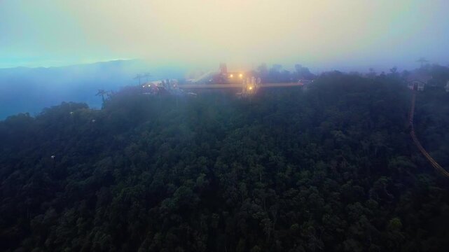 Misty Golden Hands Bridge at Dusk in Ba Na Hills near Da Nang, Vietnam &ndash; Atmospheric Aerial Drone Footage Above the Mountain Landscape