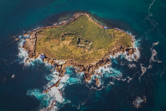 Aerial View of Baleal Island and Coastline with Waves Crashing Against Rocks