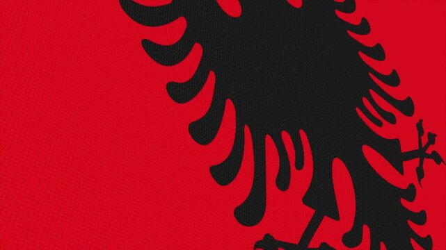Flag of Albania waving slowly in the foreground and moving upwards.