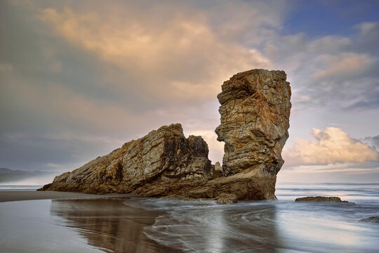 Sea stacks at the easternmost end of the Bayas sandstrip and dune system, the Playa Requexinos Beach, on a glowing dawn. Castrill&oacute;n-Asturias-Spain-046