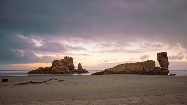 Sea stacks at the easternmost end of the Bayas sandstrip and dune system, the Playa Requexinos Beach, on a glowing dawn. Castrill&oacute;n-Asturias-Spain-043