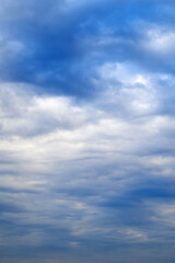 Fototapeta premium blue cloudy sky with soft wavy layers of white and light blue clouds