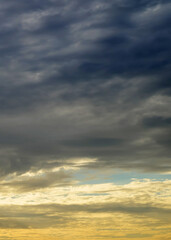 Fototapeta premium overcast twilight sky with soft orange and yellow light near horizon line