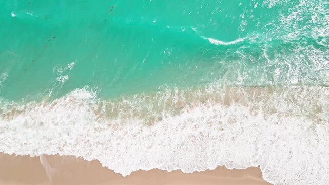 Aerial ocean sea waves. Beach shoreline sand texture. Foam pattern turquoise water. Tropical coastal summer view.