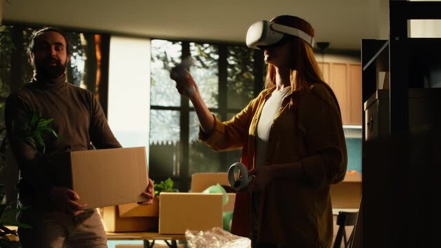 Male homeowner using VR glasses to visualize furniture and decorations for a first home, designing a floor plan and furniture arrangement in a virtual interior while planning the new house layout.