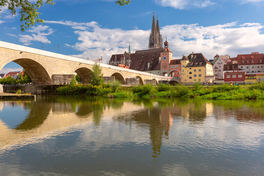Historic riverside architecture and the Stone Bridge along the Danube River in Regensburg, Bavaria, Germany.