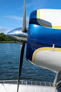 Close‑up view of a bush plane front propeller used for Alaskan travel, with metal blades and engine housing in sharp focus, highlighting rugged aviation equipment against the remote wilderness.