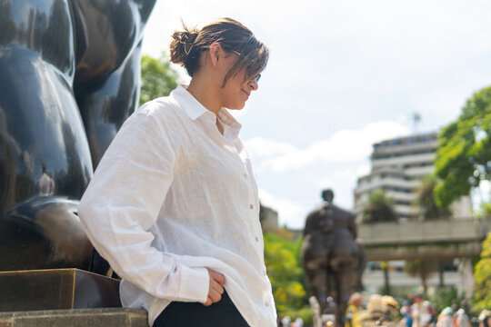 Woman traveling botero plaza enjoying medellin art and culture